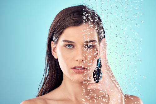 face-water-splash-and-skincare-of-woman-in-shower-2023-11-27-05-07-54-utc.jpg